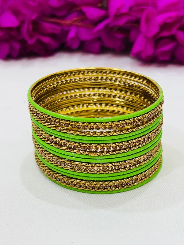 Bold Gold Bangles-Alluring Light Green Color Metal Bangles With Golden Spiral Design Work